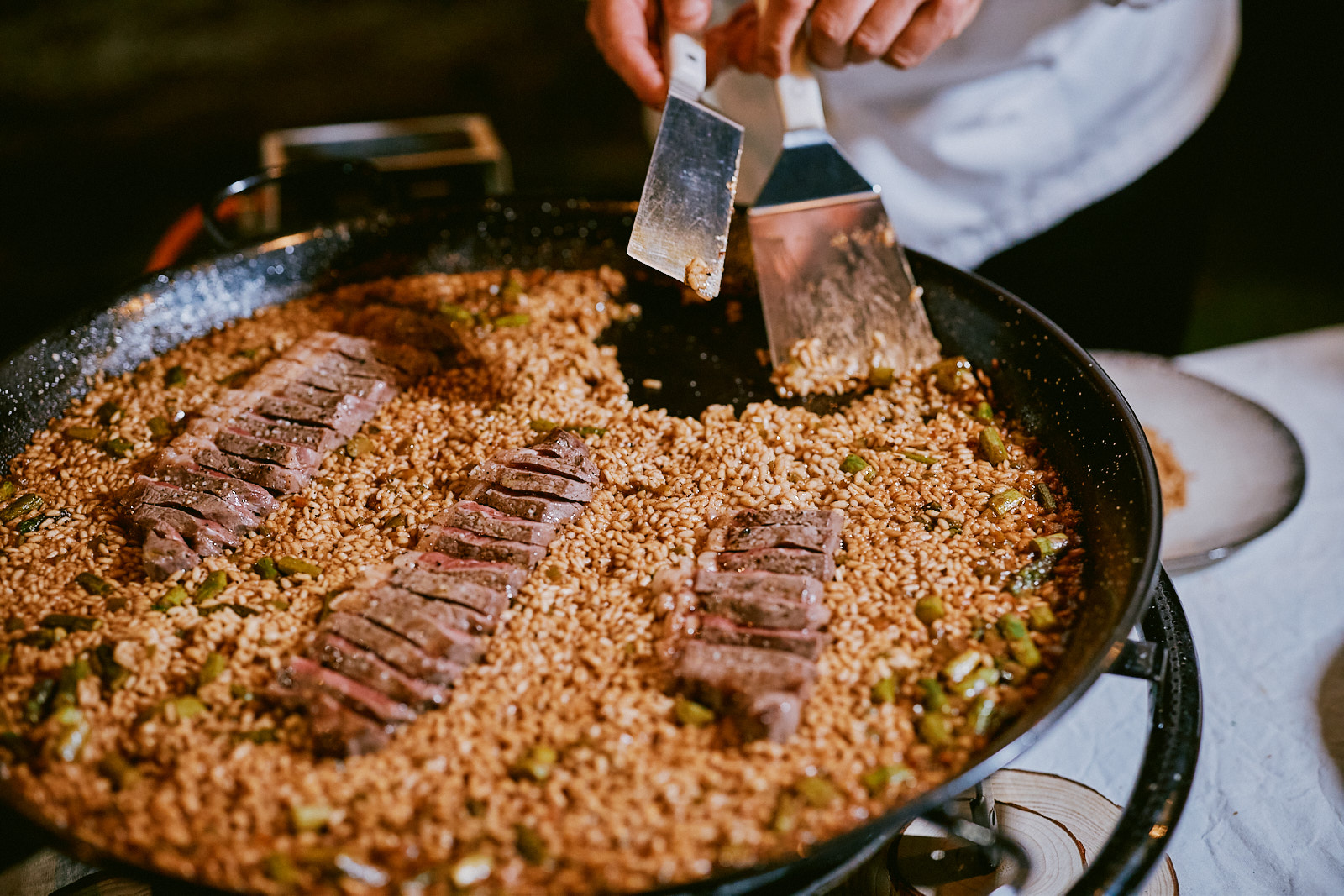 Chef serving a ribeye paella
